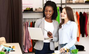 Customer interacting with employee and laptop